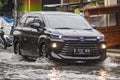 A Toyota Avanza G crashed into a flood during heavy rain on a residential street