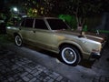 The Toyota Crown is a car that has been produced by Toyota in Japan since 1955. It is parked in the yard