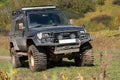 Toyota Land Cruiser Prado off-road expedition truck on autumn forest landscape