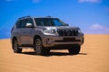 Toyota Land Cruiser Prado standing in the middle of the desert Royalty Free Stock Photo