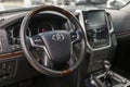 Toyota Land Cruiser 200 Series steering wheel and dashboard. Black leather interior of the SUV.