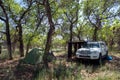 Toyota 4runner off-road suv with awning on the side and tent in forest. Offroad vehicle with camping gear