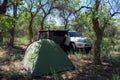 Toyota 4runner off-road suv with awning on the side and tent in forest. Offroad vehicle with camping gear