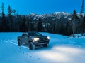Truck Driving on Snow in Blue Hour in the Mountains