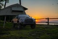 Toyota Tacoma with a tent at a forest camp