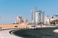 Toyota Taxi Car Moving In Street Of City Of Ajman. Building Of Bahi Ajman Palace Hotel In Sunny Day.Urban Architecture