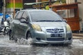 A Toyota Yaris crashed into a flood during heavy rain on a residential street