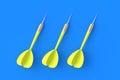 Toys for adults and children. Game for leisure. International tournament, competitions. Three yellow darts on a blue background