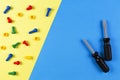 Toys background. Kids construction toys tools on light blue and yellow background. Top view Royalty Free Stock Photo