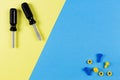 Toys background. Kids construction toys tools on blue and yellow background. Top view