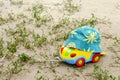 Toys car, from above a children`s hat on the sand among the gras Royalty Free Stock Photo