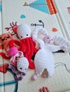 Toys in the children's room on a colorful rug. Games at home. We play with the child. Knitted toys. Hobby. Handmade