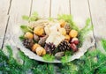 Toys for the Christmas tree and pine cones in a metal bowl, on old wooden background new Year Royalty Free Stock Photo