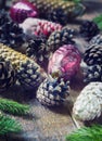 Toys for the Christmas tree and pine cones on old wooden background Royalty Free Stock Photo