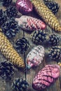 Toys for the Christmas tree and pine cones on old wooden background Royalty Free Stock Photo