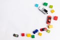 Toys constuctor and cars, top view on white background, place for text