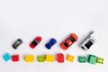 Toys constuctor and cars, top view on white background, place for text