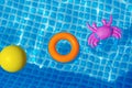toys floating in swimming pool Royalty Free Stock Photo