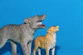 toys gray dangerous wolf and little orange wolf on a blue background