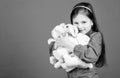 Toys for kid. small girl with soft bear toy. little girl playing game in playroom. happy childhood. Birthday. hugging a Royalty Free Stock Photo