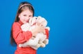 Toys for kid. small girl with soft bear toy. little girl playing game in playroom. happy childhood. Birthday. hugging a Royalty Free Stock Photo