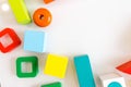 Toys kids background. Wooden cubes with numbers and colorful toy bricks on a white background. frame made of accessories for child Royalty Free Stock Photo