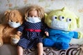 Toys in masks. A child put protective medical masks on their favorite toys during the pandemic. Royalty Free Stock Photo