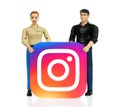 Toys people holds Instagram paper logo