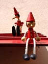 Toys of Pinocchio sitting on a surface attached to the wall