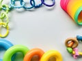 Toys of rainbow colored on greyish white background.