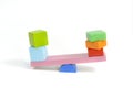 Toys seesaw wooden blocks, teeter totter on white background