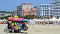 Toys seller cart with plastic toys and beach balls on the sandy beach