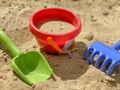 Toys shovel, rake and bucket for children`s sandbox. Children`s toys Royalty Free Stock Photo