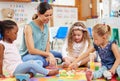 Toys, teacher and woman with education, students or ideas with conversation, lessons or teaching. Person, educator or Royalty Free Stock Photo