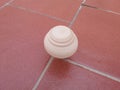 Wooden spinning top while spinning on the ground