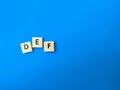 Toys word with word DEF on blue background.