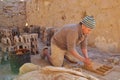 A local worker making bricks in a traditional way in a brick factory. A wooden frame is used to mold the bricks. Royalty Free Stock Photo