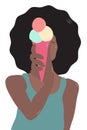 Giggling African girl with lush black hair in blue undershirt holds pink ice cream cone with three colorful balls and hides her fa Royalty Free Stock Photo