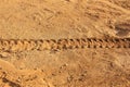 Trace of a car wheel on on the mud, soil land. Driving on desert sand after rain