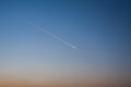 The trace of the plane in the sky, in the clear evening sky