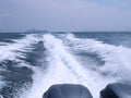 Trace tail of ferry speed boat on surface sea water. White wave view behind speed boat. Travel concept Royalty Free Stock Photo