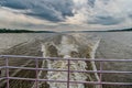 Trace on water in blue sea in manaus, brazil. Sea coast on horizon on cloudy sky. Wanderlust discovery and adventure. Speed and en