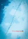 Ukrainian Concept I am staying: footprints in blue snow on frozen river surface Royalty Free Stock Photo