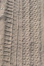 Traces of car tires on a sandy road. Background image on the theme of roads and travel Royalty Free Stock Photo