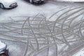 Traces of car tires on wet snow during sleet