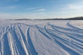 Traces of cars lead into the distance along the white snow of the frozen Big Lake. Royalty Free Stock Photo