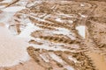 Traces of construction vehicles in mud sand and puddles at a construction site Royalty Free Stock Photo