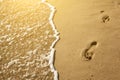 Traces of feet in the sand on the beach