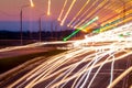 Traces of headlights from cars moving at night on the bridge, illuminated by lanterns. Abstract city landscape with highway Royalty Free Stock Photo
