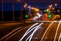 Traces of headlights from cars moving at night on the bridge, illuminated by lanterns. Abstract city landscape with highway Royalty Free Stock Photo